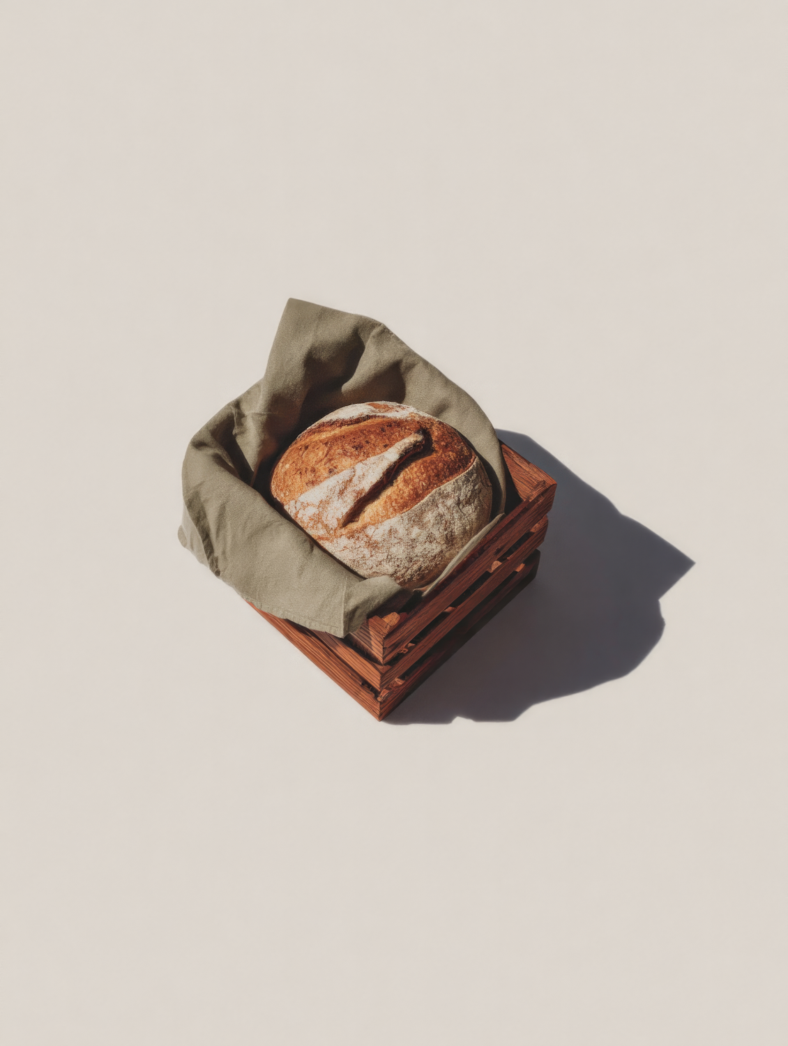 Fresh artisan bread loaves in a wooden crate